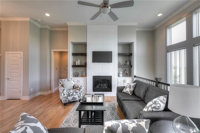 14608 Aspen Cir, Basehor, KS 66007 - living room featuring baseboards, ornamental molding, a ceiling fan, wood finished floors, and a large fireplace