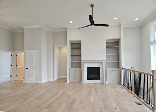 14608 Aspen Cir, Basehor, KS 66007 - unfurnished living room with a ceiling fan, light wood finished floors, ornamental molding, recessed lighting, and a fireplace