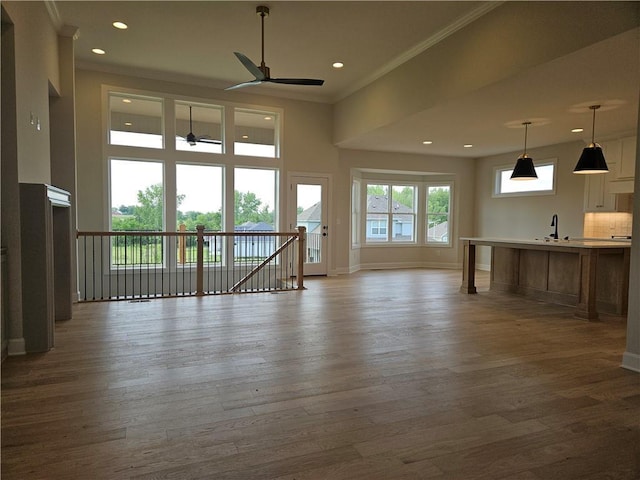 14608 Aspen Cir, Basehor, KS 66007 - unfurnished living room featuring ceiling fan, crown molding, dark wood-type flooring, and recessed lighting