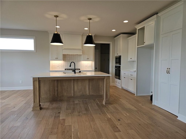 14608 Aspen Cir, Basehor, KS 66007 - kitchen with light countertops, white cabinetry, light wood-style flooring, and recessed lighting