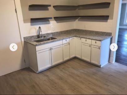 kitchen featuring white cabinetry, sink, and dark wood-type flooring