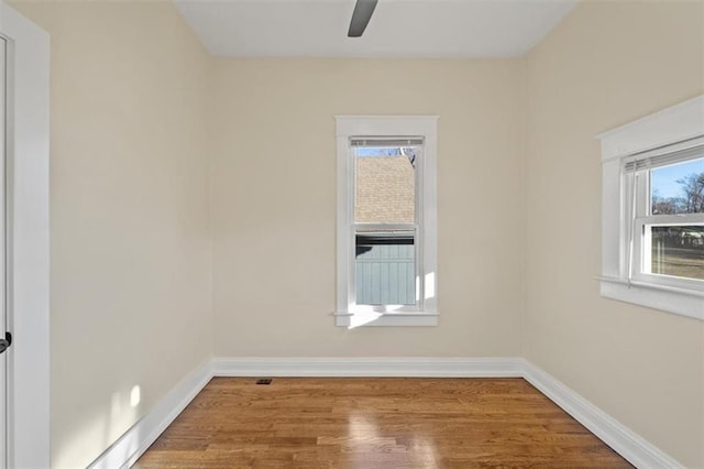 empty room featuring wood-type flooring and ceiling fan