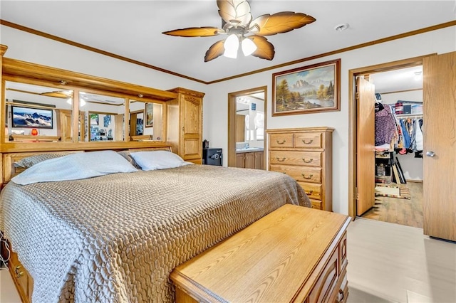 bedroom with ceiling fan, light wood-type flooring, a walk in closet, a closet, and ornamental molding