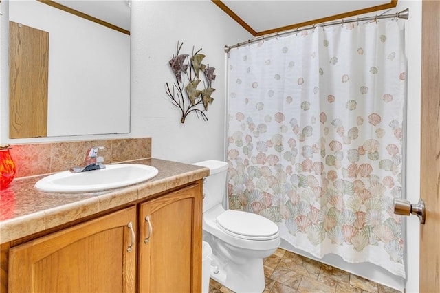 bathroom featuring backsplash, vanity, toilet, and crown molding