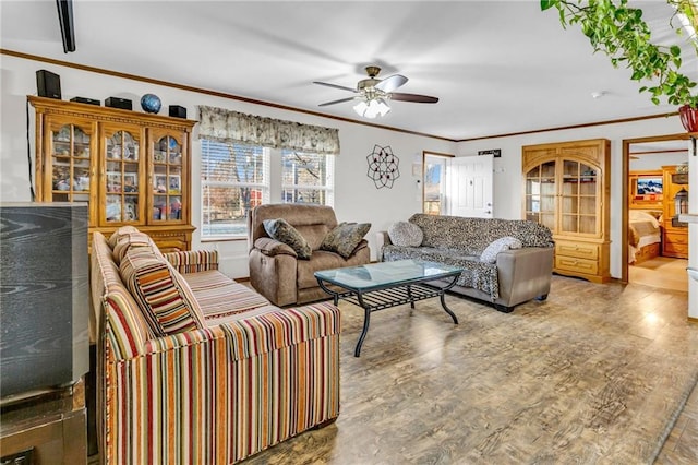 living room with hardwood / wood-style flooring, ceiling fan, and crown molding