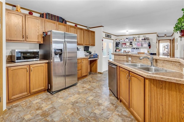 kitchen with sink, ornamental molding, and stainless steel appliances