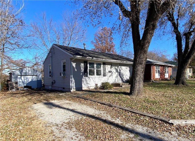 view of front of property with an outbuilding, cooling unit, and a garage