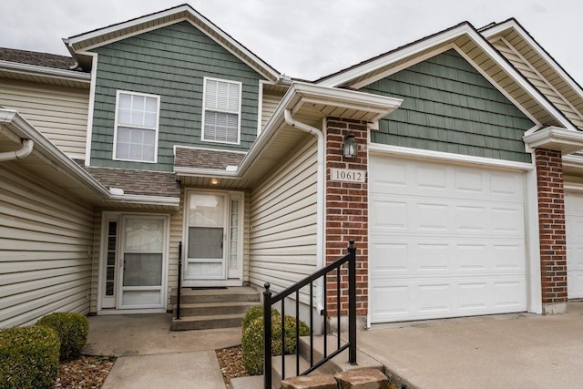 doorway to property with a garage