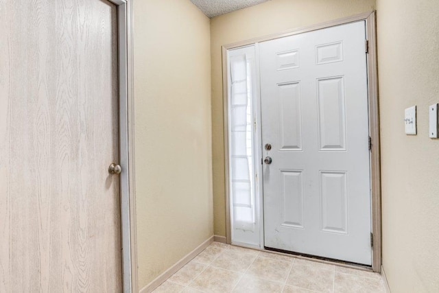 foyer entrance with light tile patterned floors