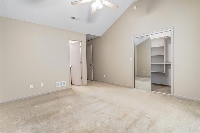 unfurnished bedroom featuring ceiling fan, lofted ceiling, light carpet, and a closet