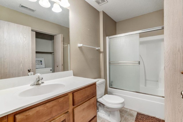 full bathroom with vanity, bath / shower combo with glass door, tile patterned flooring, toilet, and a textured ceiling