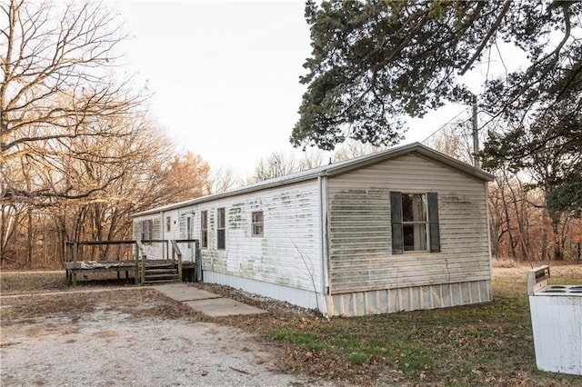 view of property exterior with a wooden deck