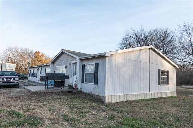 view of side of property with a patio