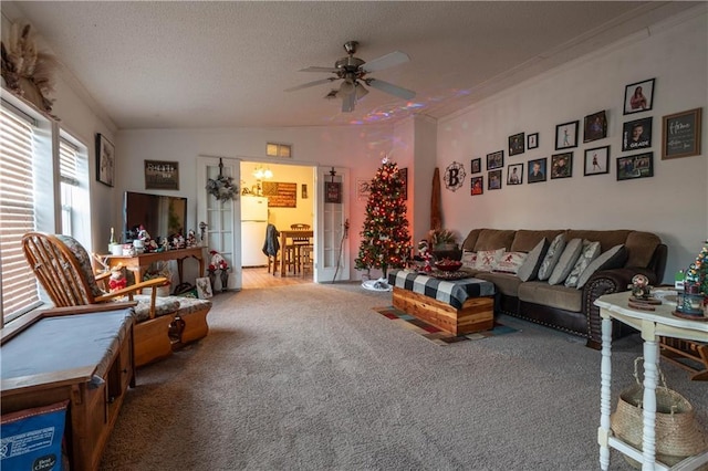 carpeted living room featuring a textured ceiling, ceiling fan, lofted ceiling, and crown molding