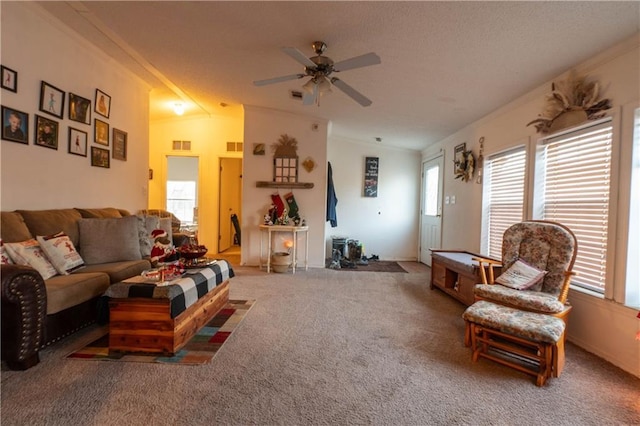 living room with carpet, a wealth of natural light, and ceiling fan