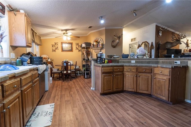 kitchen with ceiling fan, wood-type flooring, and a textured ceiling