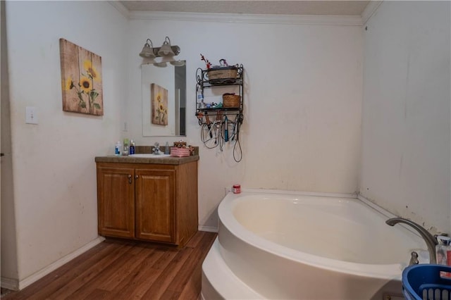 bathroom featuring vanity, a bath, wood-type flooring, and crown molding