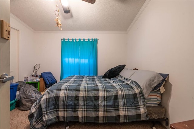 carpeted bedroom featuring ceiling fan, ornamental molding, and a textured ceiling