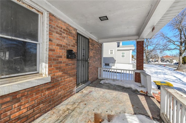 snow covered patio with covered porch