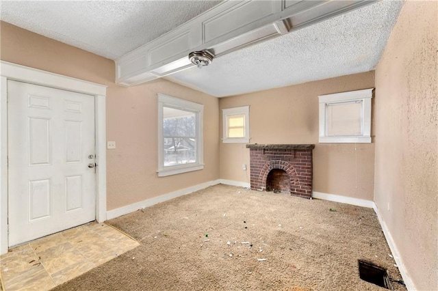 unfurnished living room with a textured ceiling and a fireplace