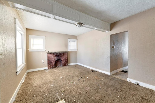 unfurnished living room with a textured ceiling and a fireplace