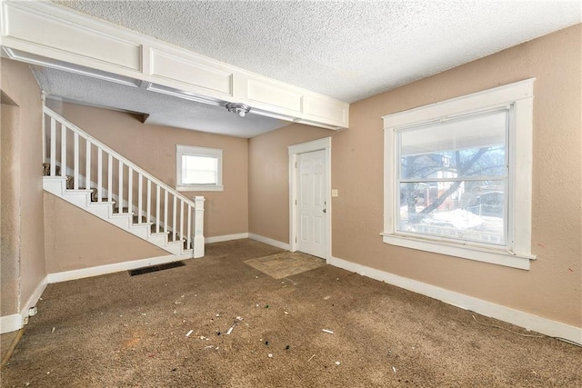 entryway with a textured ceiling