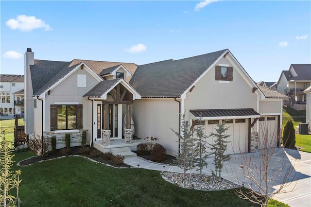 view of front of home featuring a garage, central air condition unit, and a front yard