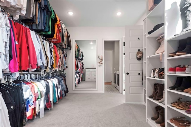 spacious closet featuring light colored carpet