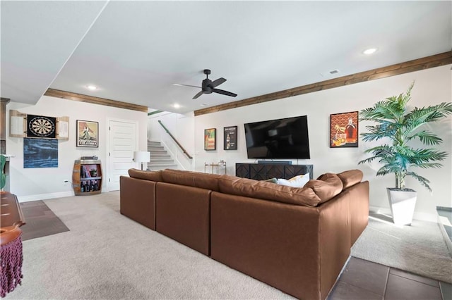 carpeted living room with ceiling fan and crown molding