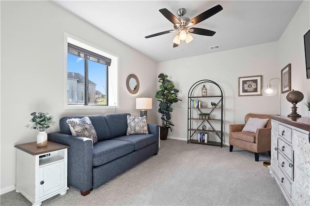 carpeted living room featuring ceiling fan