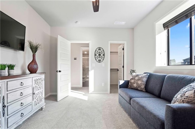 carpeted living room with ceiling fan