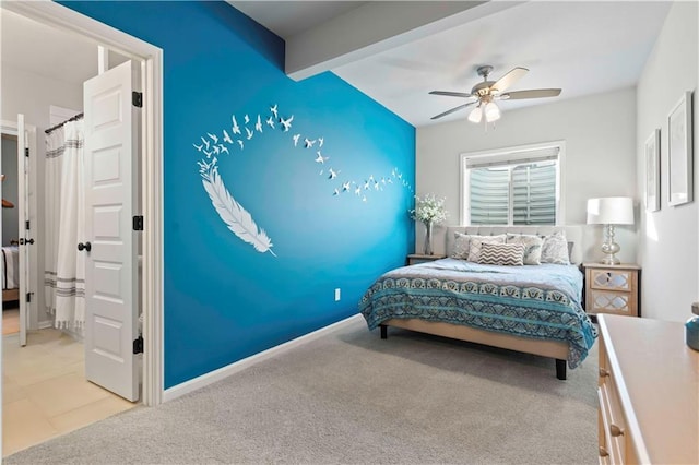 bedroom with beamed ceiling, light carpet, and ceiling fan