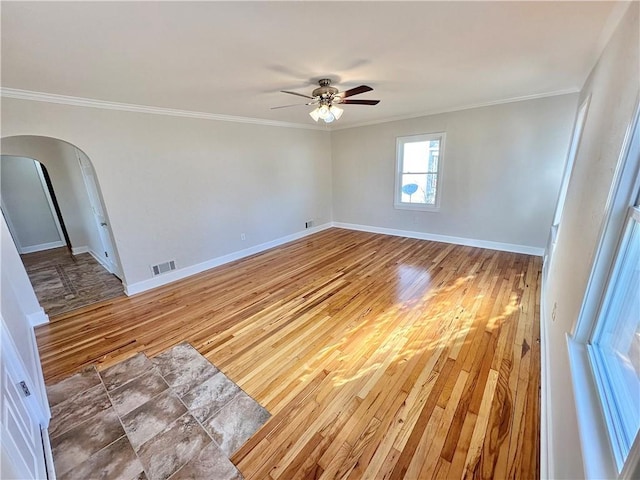 unfurnished room with hardwood / wood-style floors, ceiling fan, and ornamental molding