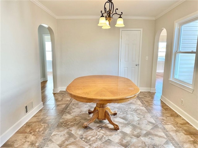 unfurnished dining area with a notable chandelier and crown molding