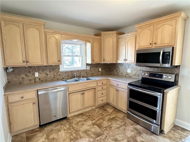 kitchen featuring decorative backsplash, sink, light brown cabinets, and appliances with stainless steel finishes