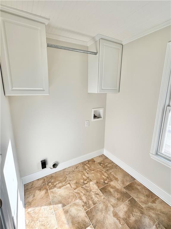 laundry room with cabinets, crown molding, and hookup for a washing machine