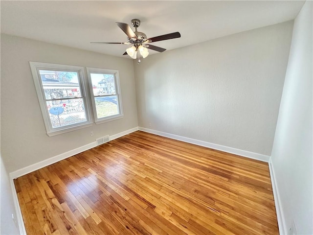 empty room featuring light wood-type flooring and ceiling fan