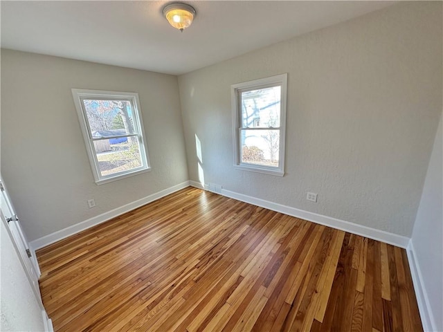 empty room featuring a healthy amount of sunlight and light wood-type flooring