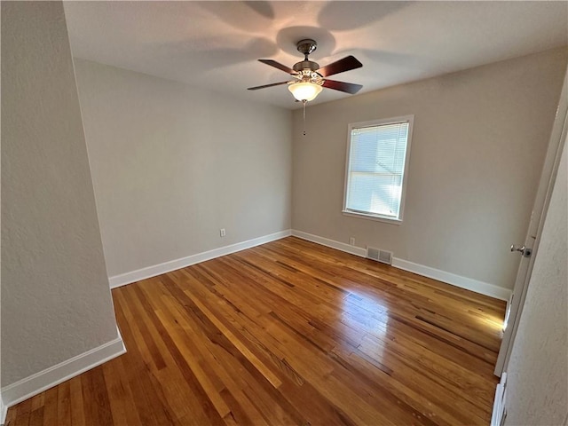 spare room with wood-type flooring and ceiling fan