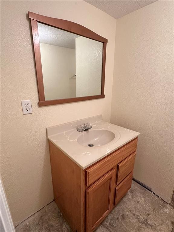 bathroom with vanity and a textured ceiling