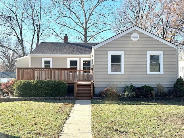 view of front facade with a front yard and a wooden deck