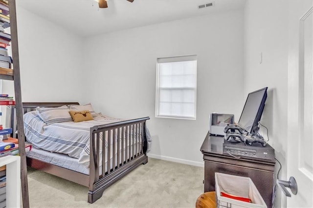 carpeted bedroom with a ceiling fan, visible vents, and baseboards