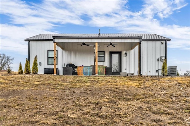 back of house with ceiling fan, metal roof, board and batten siding, and central air condition unit