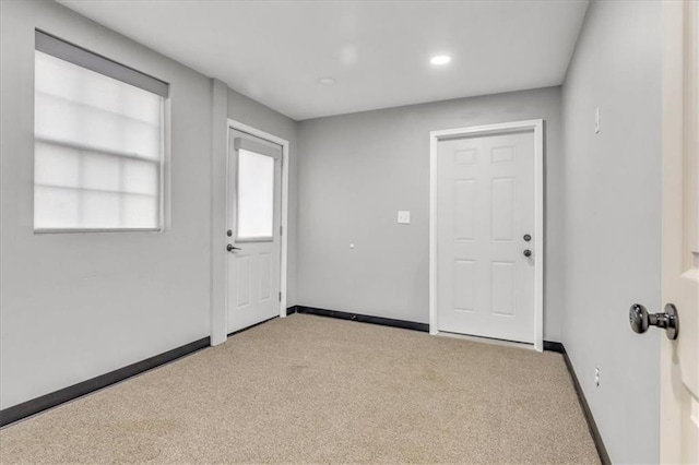 carpeted empty room featuring recessed lighting and baseboards