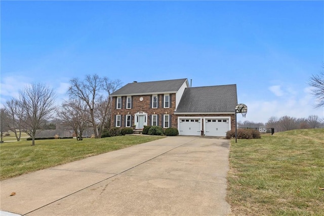 colonial inspired home featuring a garage, brick siding, driveway, and a front yard