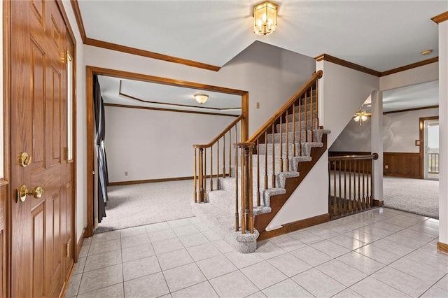 carpeted foyer entrance with ornamental molding