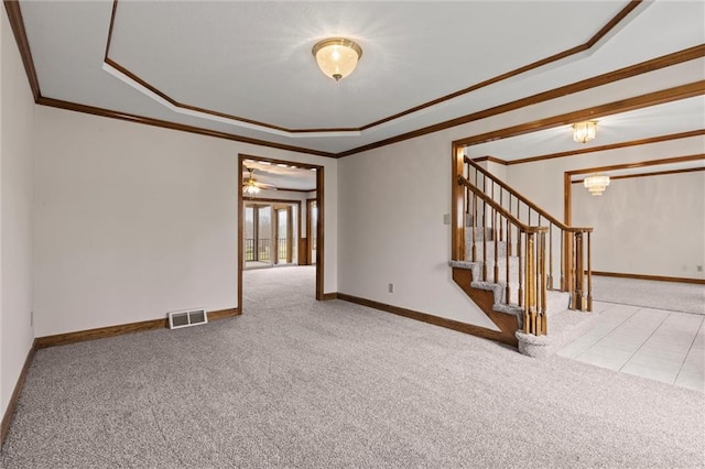 unfurnished room featuring a tray ceiling, crown molding, carpet, and ceiling fan with notable chandelier