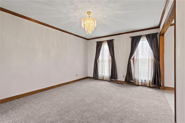 carpeted empty room featuring a chandelier and crown molding