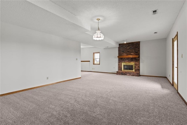 unfurnished living room featuring a textured ceiling, carpet flooring, and a fireplace