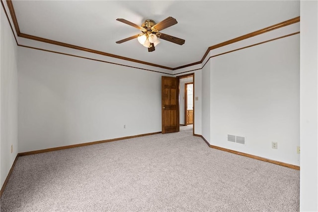 spare room with light colored carpet, ceiling fan, and crown molding